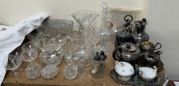 A mallet shaped glass decanter together with other glass decanters, drinking glasses,