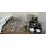 A mallet shaped glass decanter together with other glass decanters, drinking glasses,