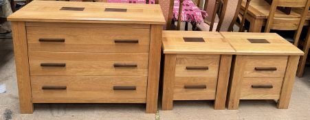 A modern oak chest with three long drawers together with a pair of matching bedside chests