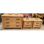 A modern oak chest with three long drawers together with a pair of matching bedside chests