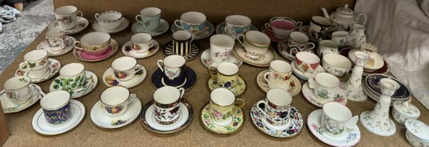 A large collection of Royal Worcester cabinet cups and saucers, including Enchantment pattern,