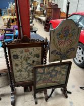 A 19th century mahogany pole screen with a shield shaped woolwork panel on a tripod base together