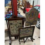 A 19th century mahogany pole screen with a shield shaped woolwork panel on a tripod base together