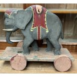 An elephant pull along toy painted in grey,