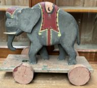 An elephant pull along toy painted in grey,