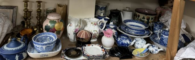 A 19th century English porcelain jug painted with sprays of garden flowers together with other jugs