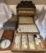 A Chinese Mah Jong set with five drawers of bone and bamboo counters in a carved cabinet together