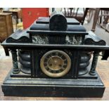 A black slate mantle clock of architectural form with Roman numerals