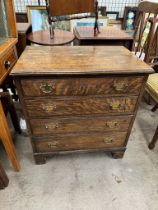 An oak chest with a rectangular top above four drawers on bracket feet