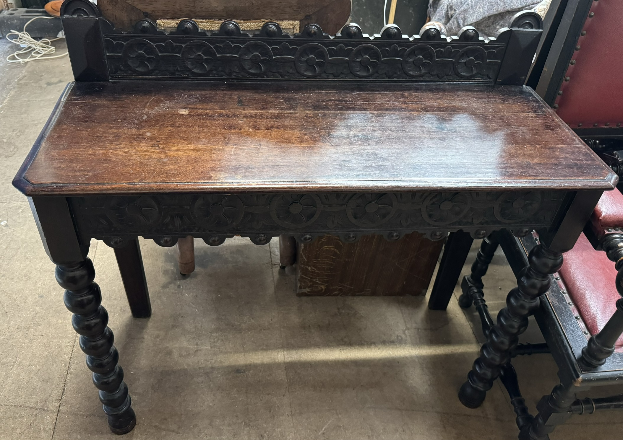 A 19th century oak side table with a carved rail,