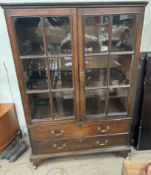 A 19th century oak display cabinet with a pair of glazed doors,