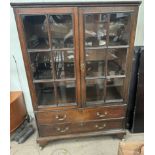 A 19th century oak display cabinet with a pair of glazed doors,