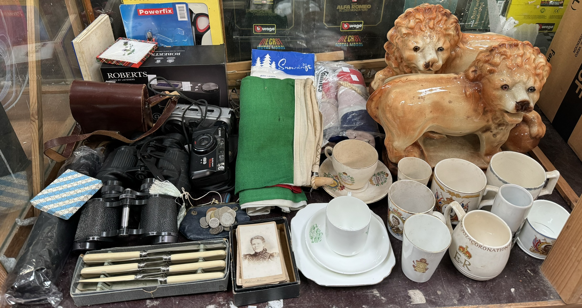 A pair of Staffordshire lions together with commemorative china, flags, binoculars, cameras, radio,