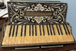 A piano accordion with 64 mother of pearl keys and buttons,