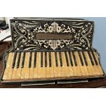 A piano accordion with 64 mother of pearl keys and buttons,