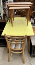 A nest of three teak tables together with a formica topped kitchen table and two chairs