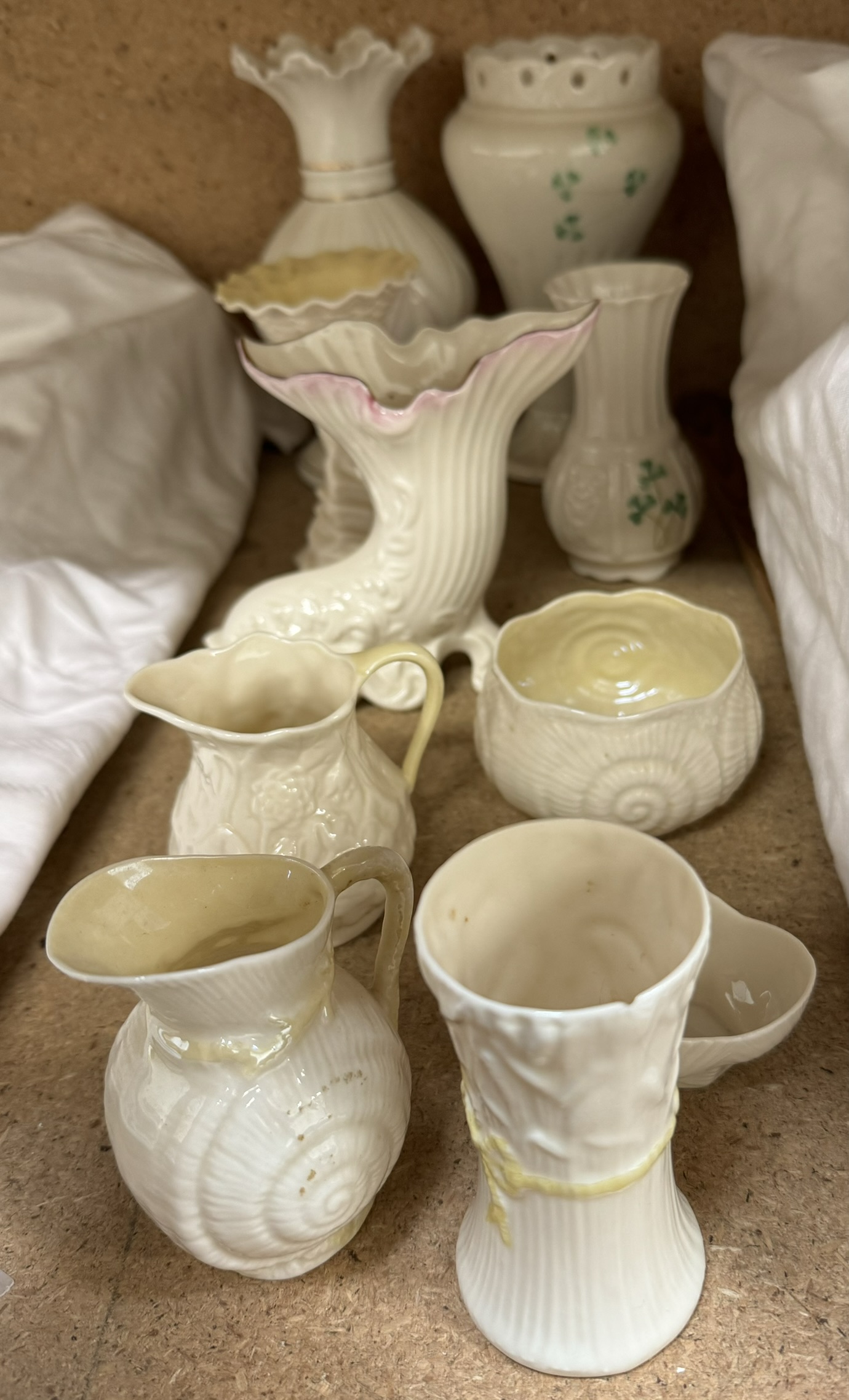 A collection of Belleek porcelain vases, jugs,