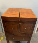 A 19th century mahogany Gentleman's washstand with a rise and fall mirror, fold over top,