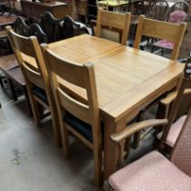 A modern oak dining table and four chairs