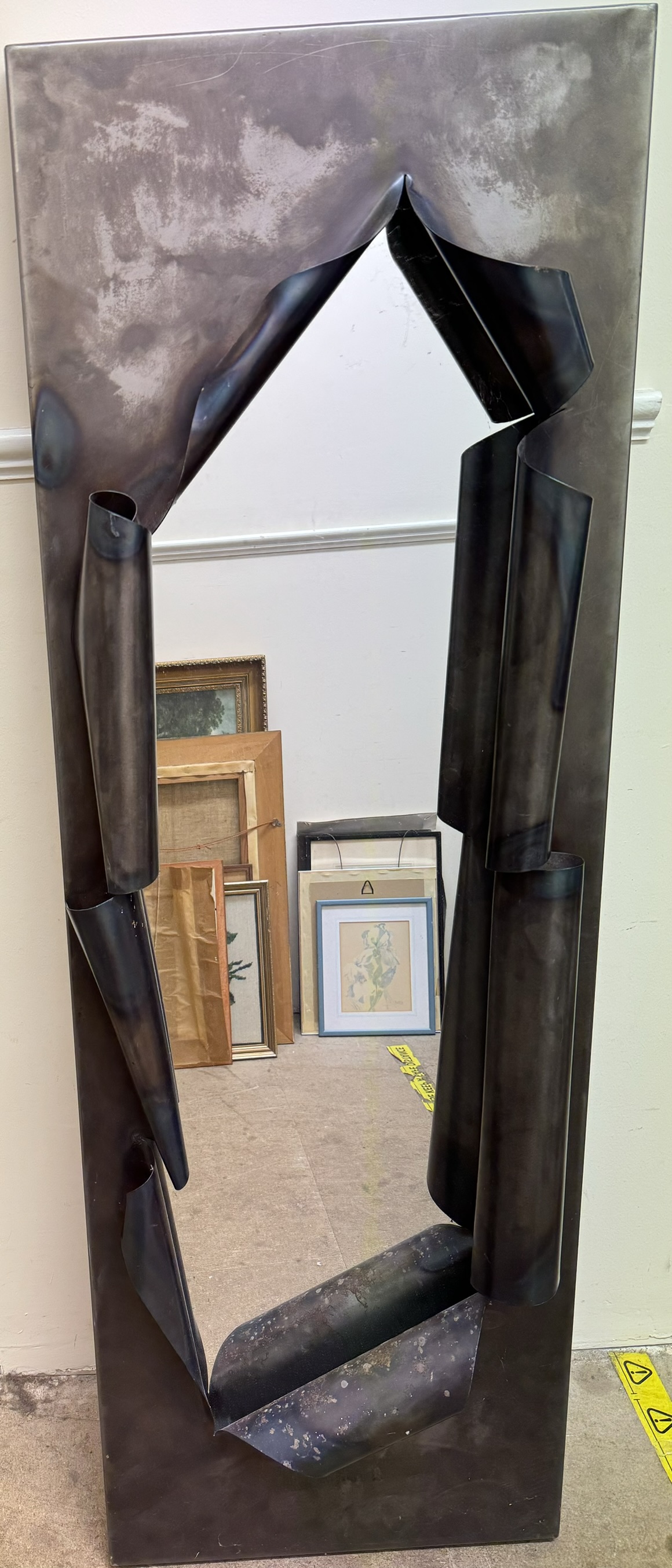 A rectangular wall mirror in the form of a torn metal panel