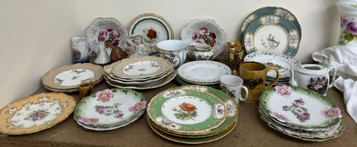 A Mintons porcelain plate painted with flowers and gilt scrolls and leaves to an orange border,