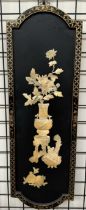 A Japanese lacquer and mother of pearl panel depicting a still life study of a vase of flowers