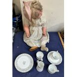 A doll together with a part tea service