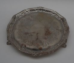 An Edwardian silver salver with a gadrooned edge, on three feet, London, 1902,