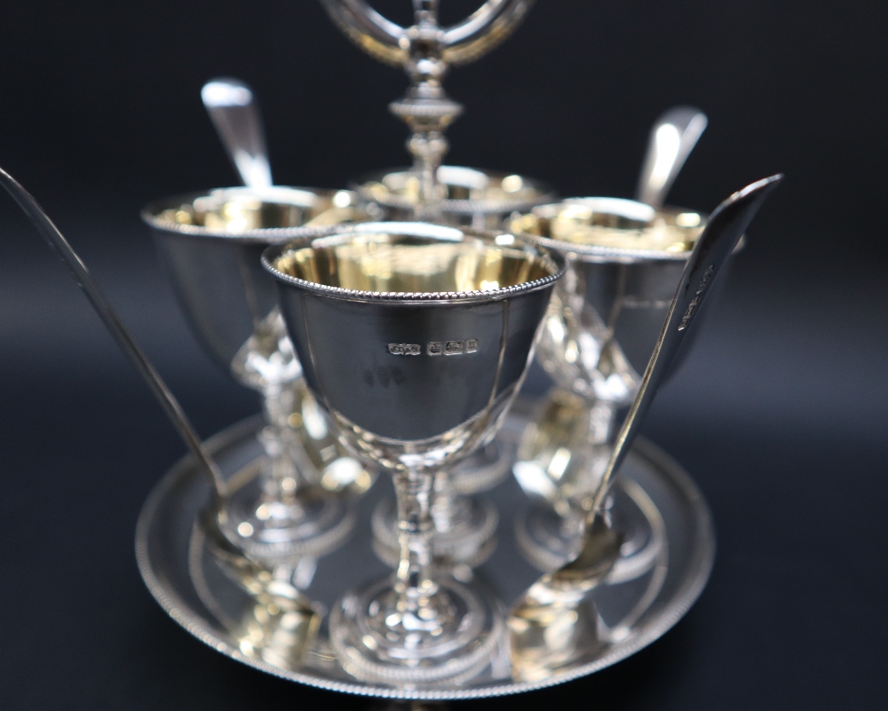 A George V silver egg cup set, comprising four egg cups with gilt interiors, - Image 2 of 4