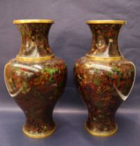 A pair of Japanese cloisonne baluster vases, decorated with flowers and leaves to a brown ground,