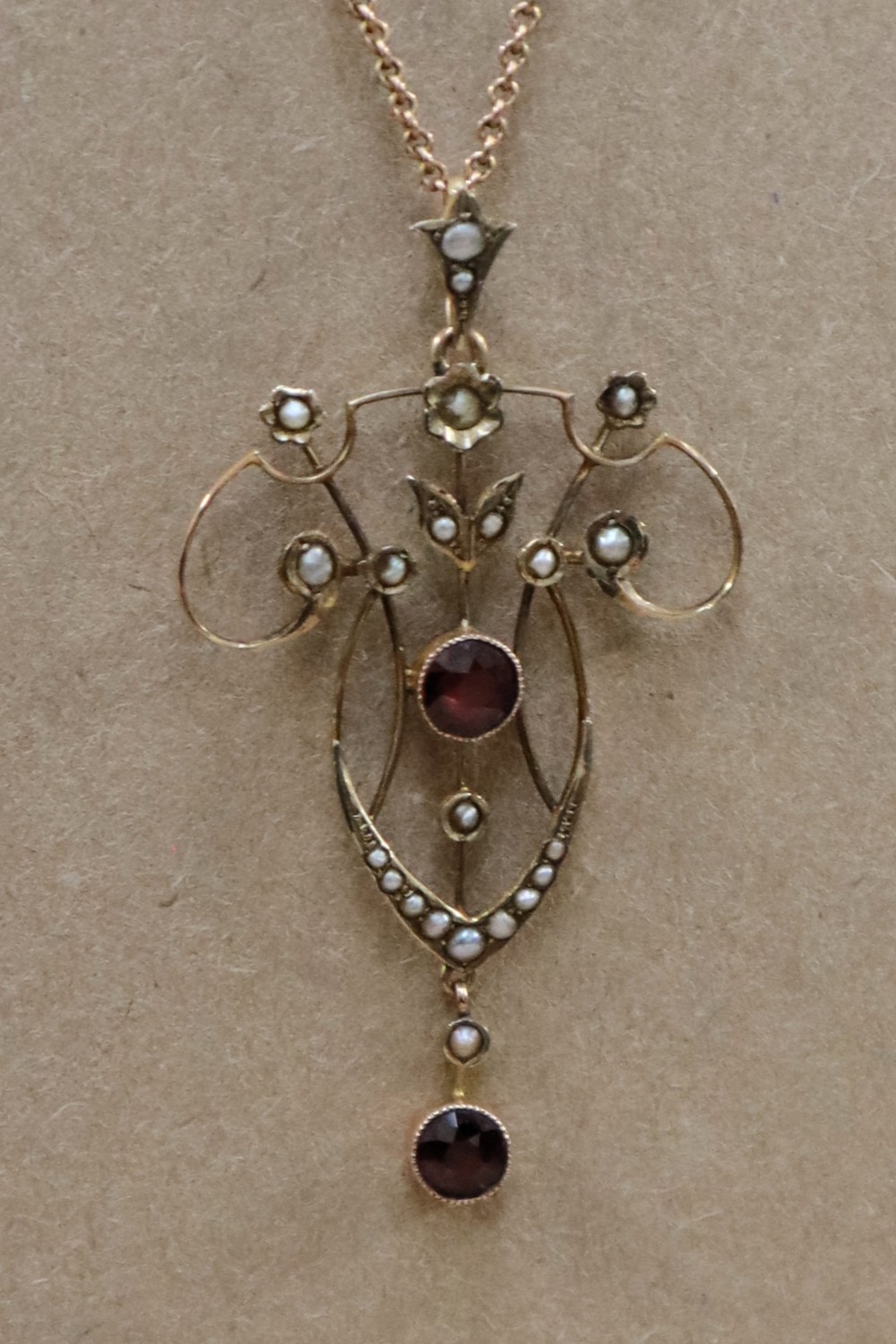 An Edwardian 9ct yellow gold garnet and seed pearl pendant on a 9ct gold chain, - Image 2 of 6