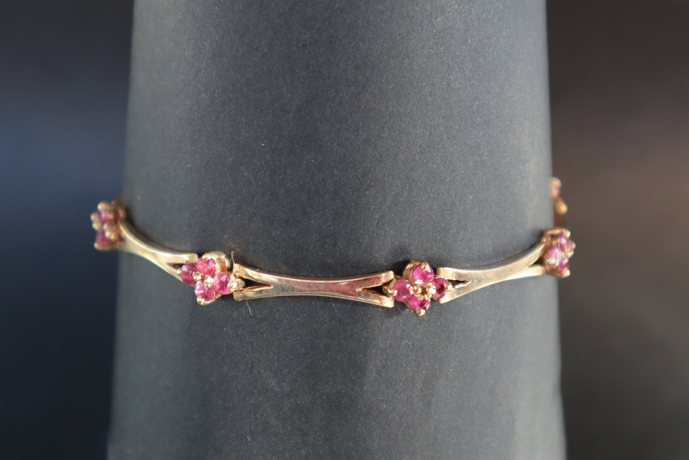 A 14ct yellow gold bracelet set with eight clusters of four rubies, 19cm long, - Image 2 of 4