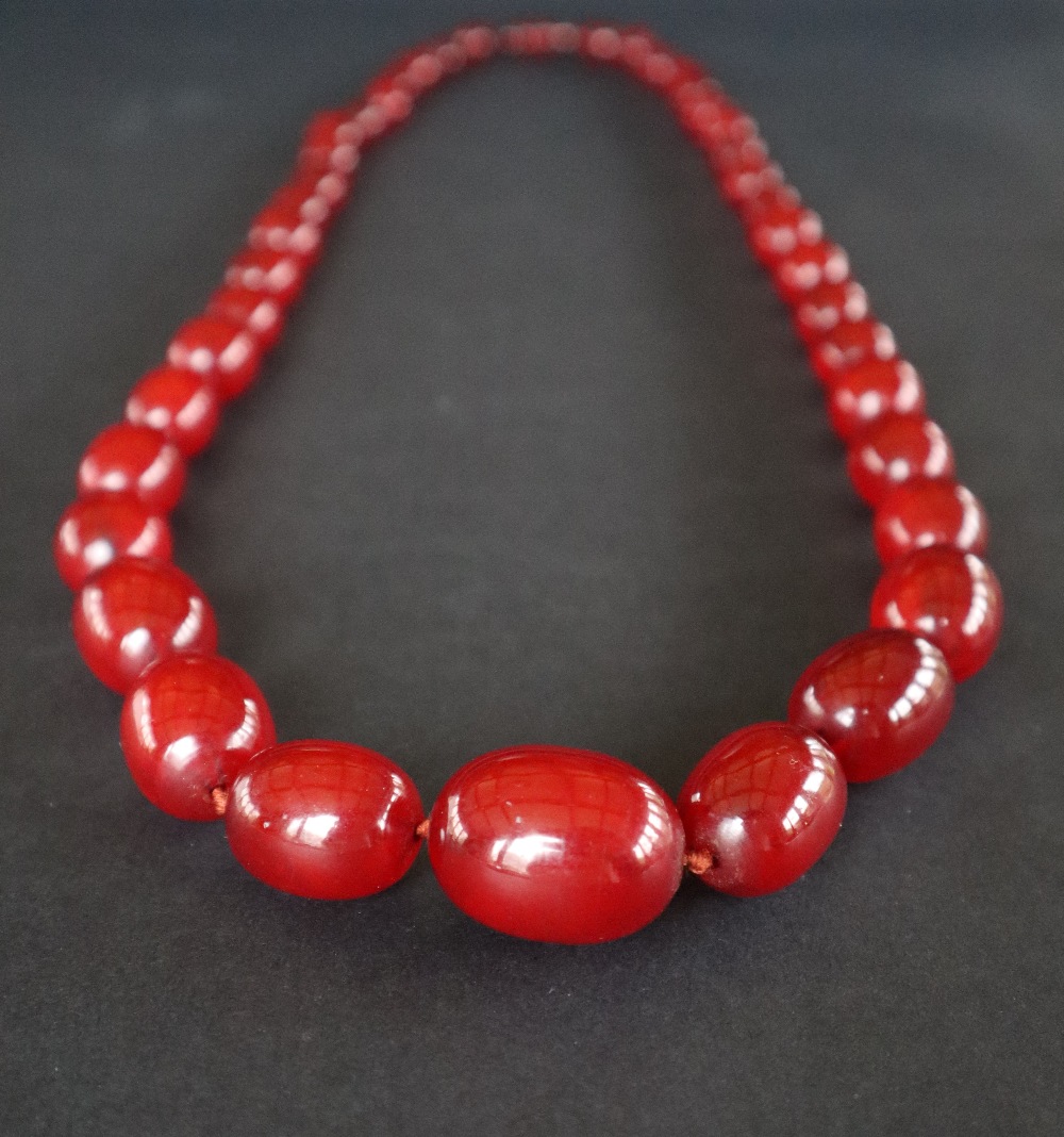 A string of cherry amber / bakelite beads, - Image 2 of 8