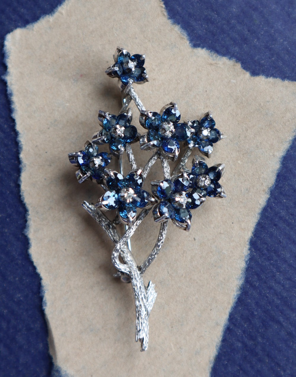 A sapphire and diamond brooch, of floral design,