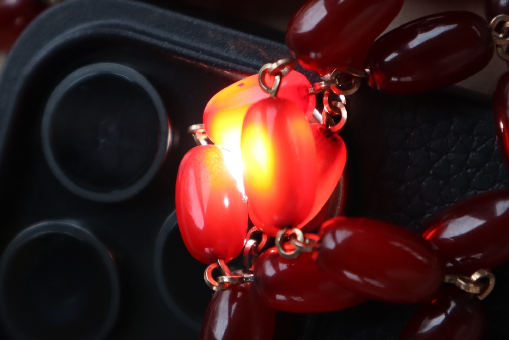 A string of cherry amber / bakelite beads, - Image 12 of 12