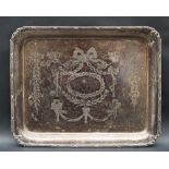 A George V silver dressing table tray of rectangular form with a line and bow border,