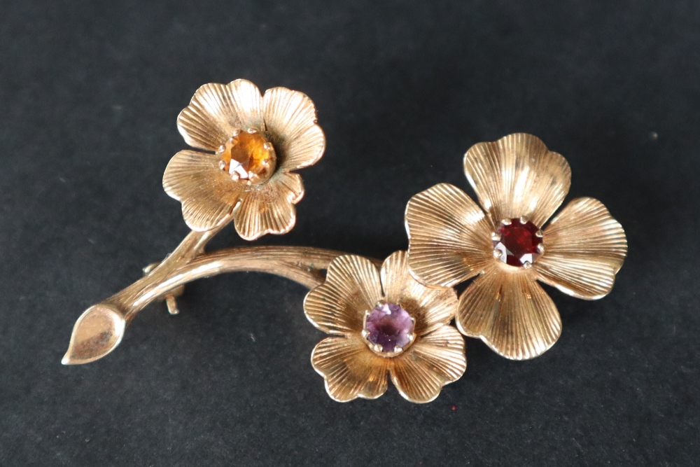 A 9ct gold brooch of floral form set with a garnet, - Image 3 of 4