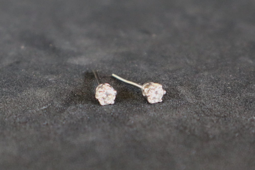 A pair of diamond stud earrings, each set with round brilliant cut diamonds, approximately 0. - Image 3 of 3