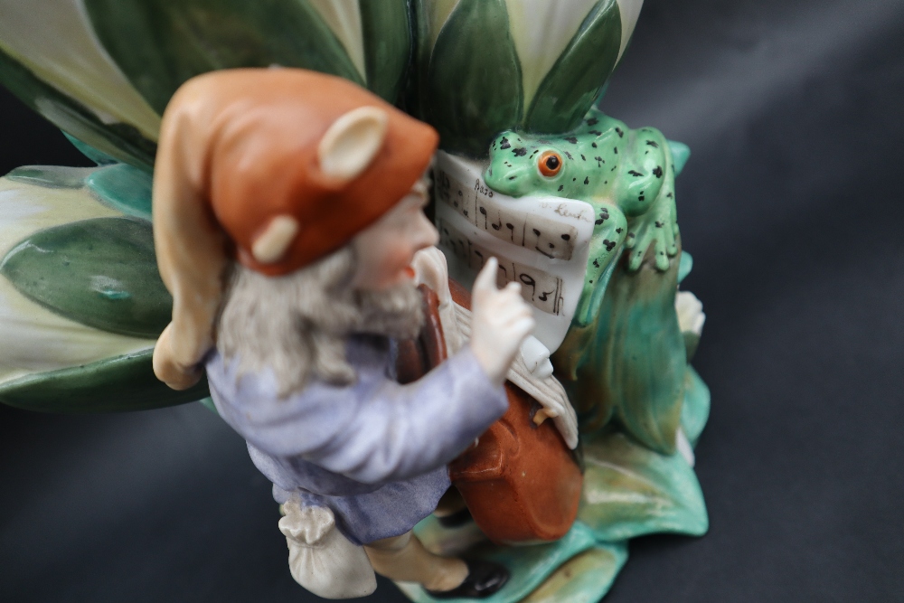 A continental porcelain triple lily vase moulded with a bearded sprite playing a cello with the - Image 4 of 9