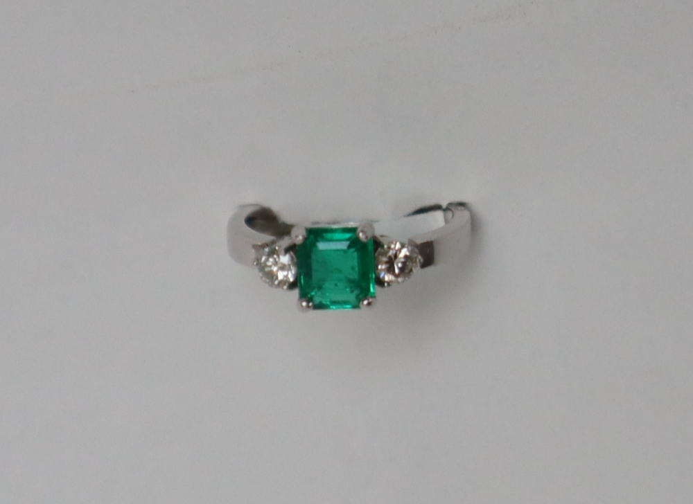 An emerald and diamond ring set with a central emerald cut emerald approximately 6mm x 5mm, - Image 2 of 5