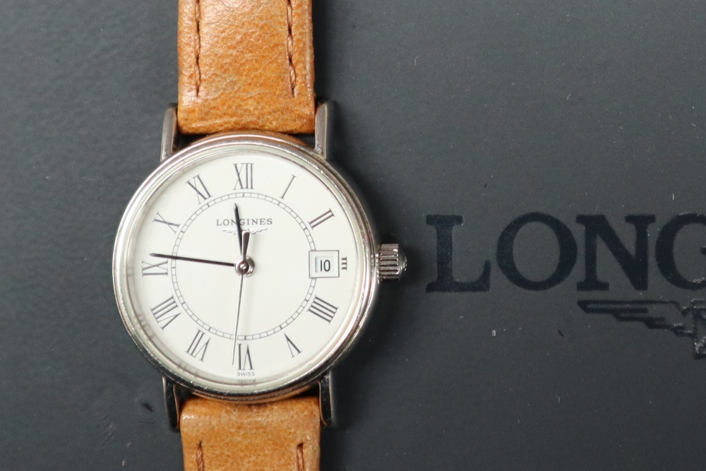 A lady's Stainless Steel Longines wristwatch with a white dial and Roman numerals and a date