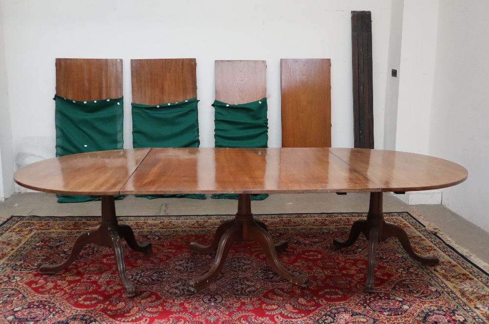 An early 19th century mahogany triple pedestal dining table in the manner of Gillows with a pair of