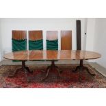 An early 19th century mahogany triple pedestal dining table in the manner of Gillows with a pair of