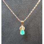 An emerald and diamond drop pendant, set with a pear shaped emerald approximately 3.