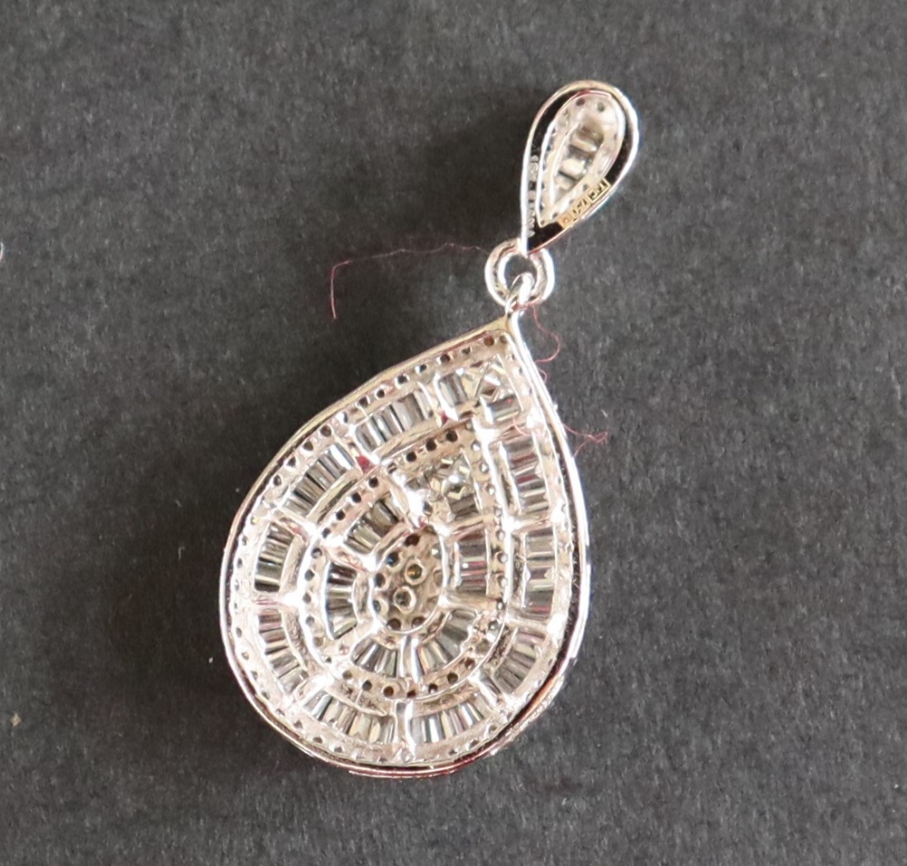 An 18ct white gold pendant set with approximately one hundred and seventy natural baguette, - Image 6 of 6