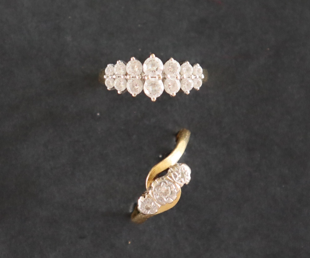 A three stone diamond ring set with round old cut diamonds to a white metal setting and 18ct gold