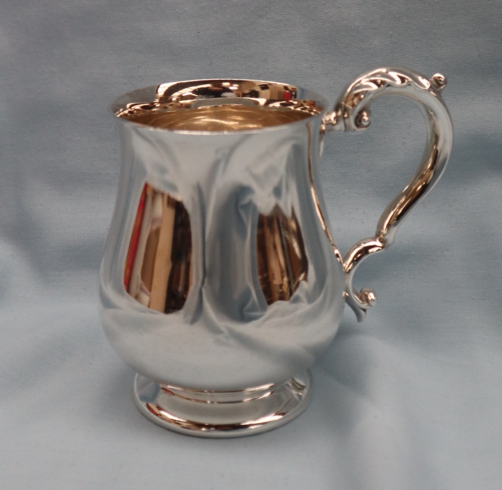 An Elizabeth II silver tankard of baluster form with a leaf capped scrolling handle on a spreading - Image 6 of 6