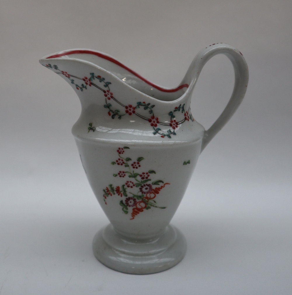 A Newhall porcelain milk jug of oval form and tapering body on a spreading foot painted with