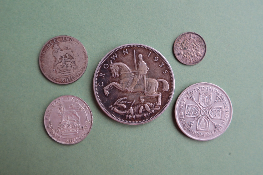 A George V 'Rocking Horse' crown dated 1935 together with four other George V coins including a - Image 2 of 2