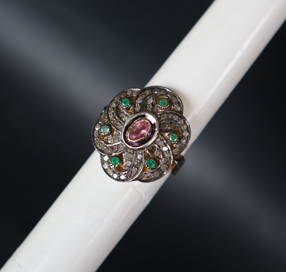 A tourmaline, emerald and diamond dress ring set with a central pink tourmaline,